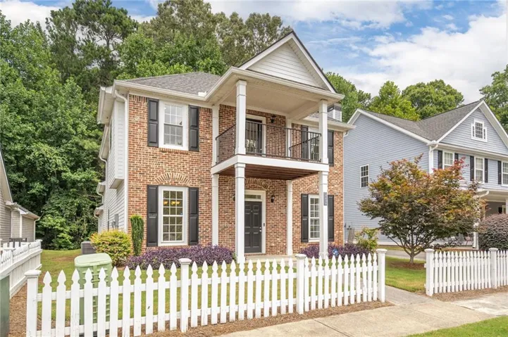 Brick and siding exterior with a second-story balcony