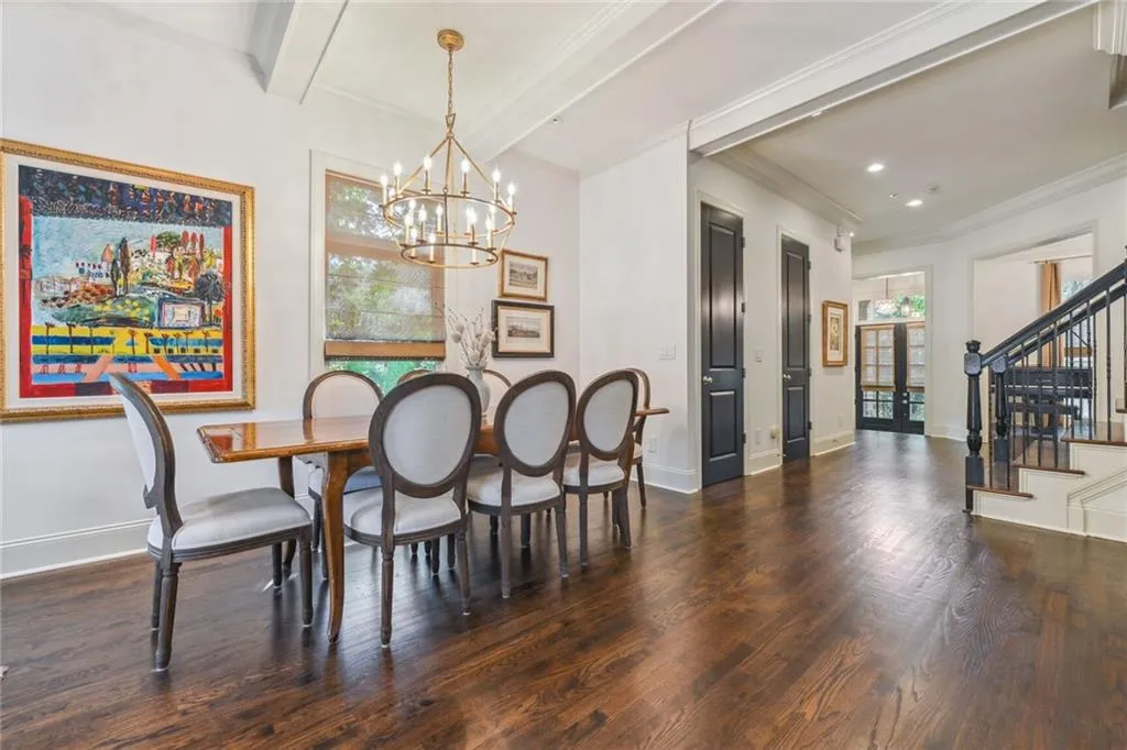Casual dining featuring beamed ceiling, and an inviting chandelier