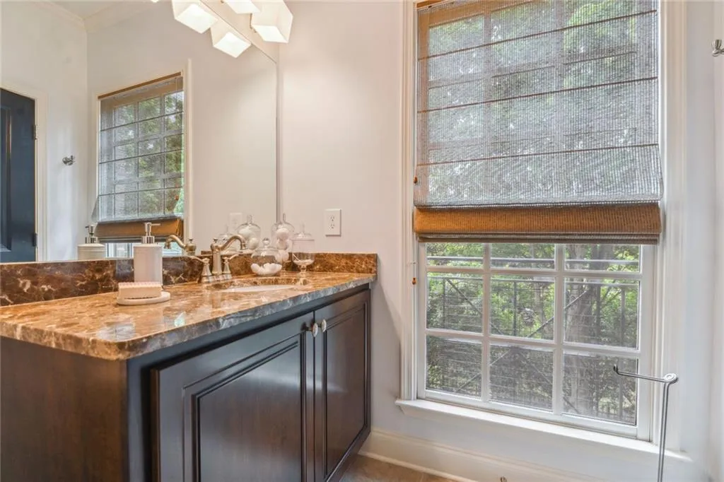 3rd floor ensuite bathroom includes lots of natural light and marble countertops.