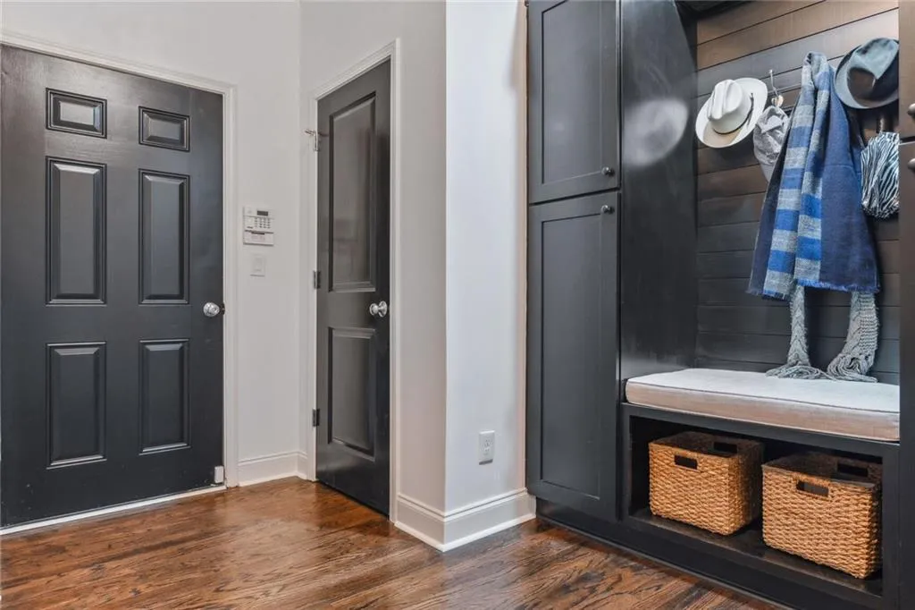 Entry way from garage includes built in cabinetry.