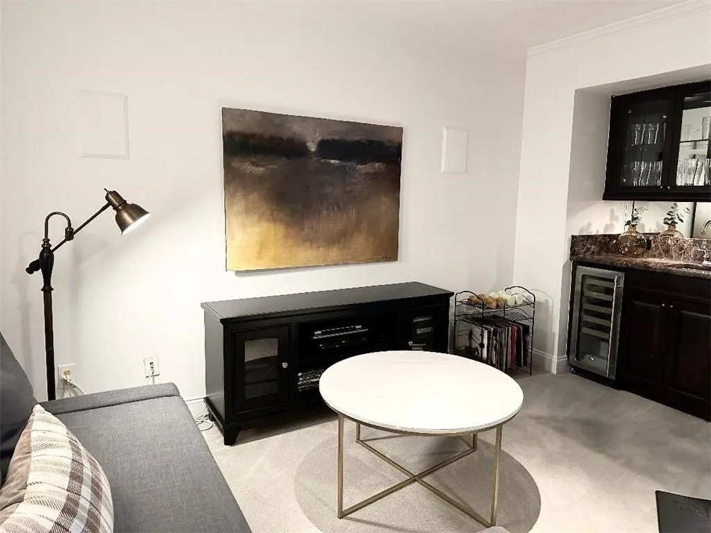 Spacious 4th floor is currently being used for a teen suite but is wired for a home theater, includes a wet bar, with a sink, beverage refrigerator, and a wine refrigerator.