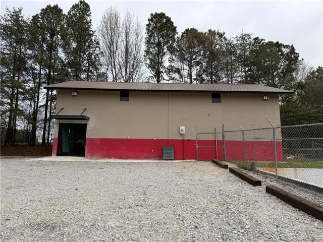View of property exterior featuring a metal roof and a cooling unit