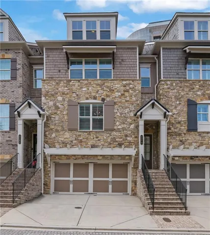 Stone and shingle facade featuring decorative shutters