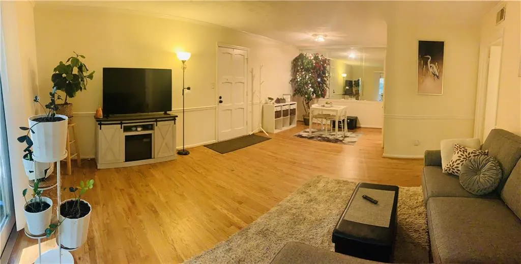 Living room with light wood-style floors and baseboards