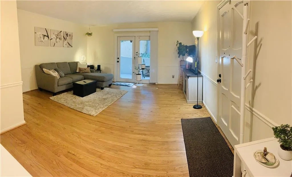 Living area featuring light wood-style flooring and french doors