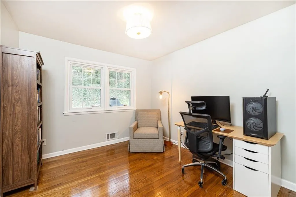 Office space with baseboards and hardwood / wood-style floors