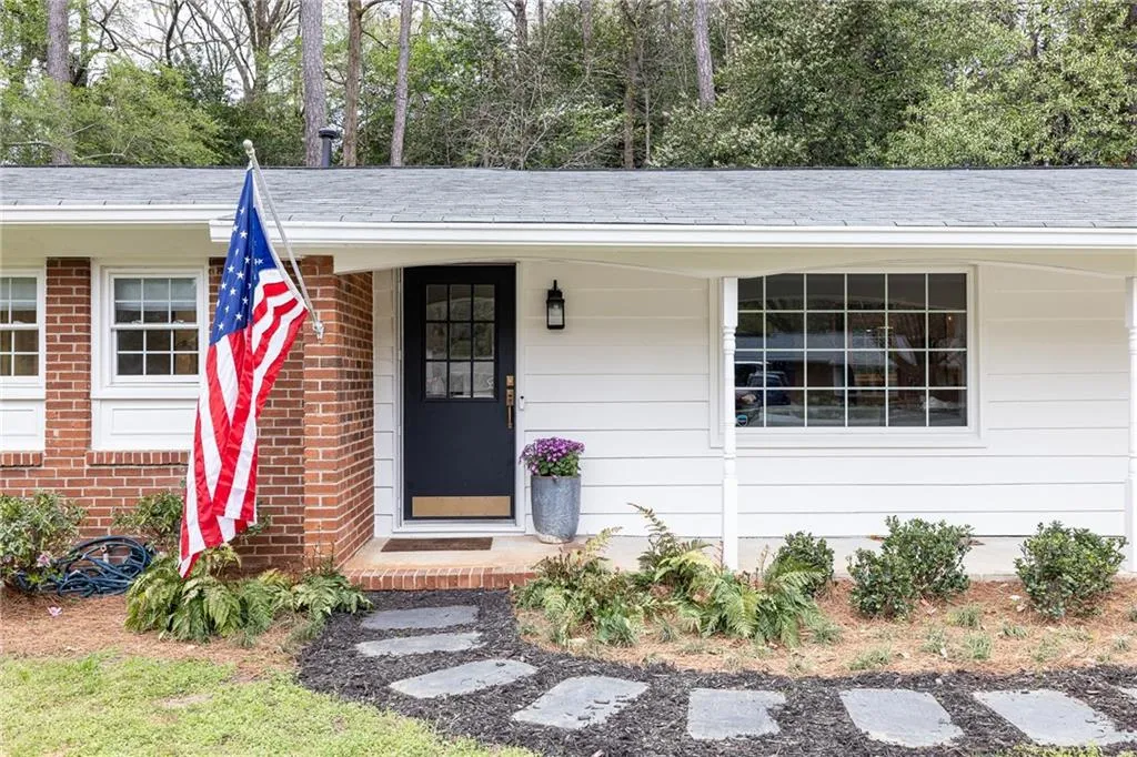 Property entrance featuring brick siding