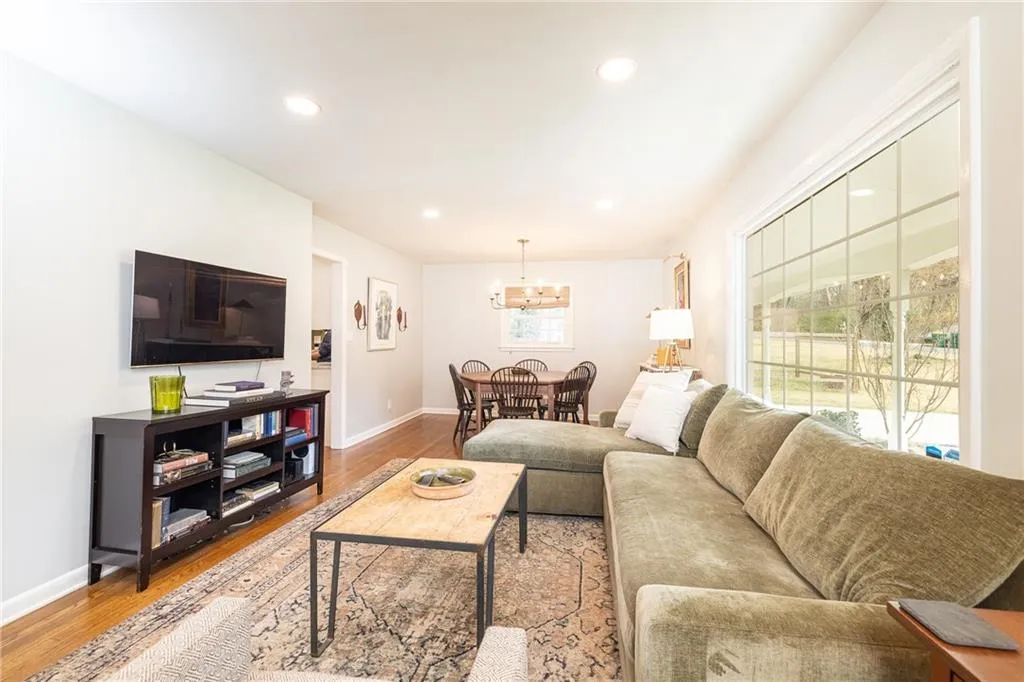 Living area with light wood-style flooring and hanging lights