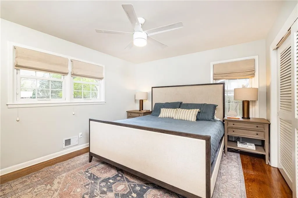 Bedroom featuring wood finished floors, a closet, and a ceiling fan