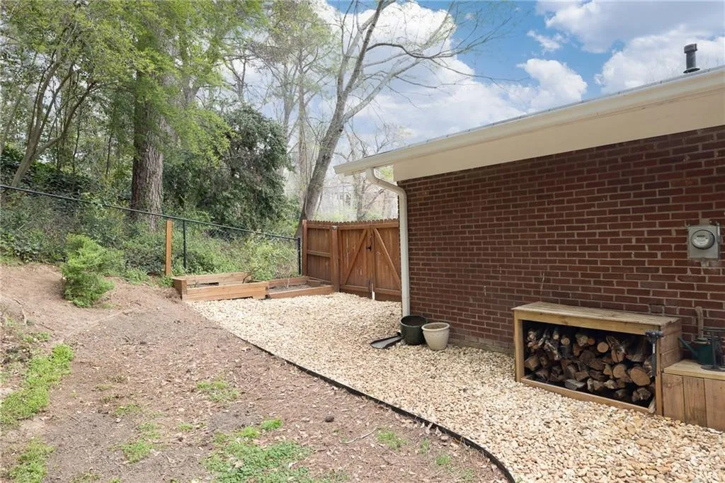 Fenced backyard with a gate and a garden