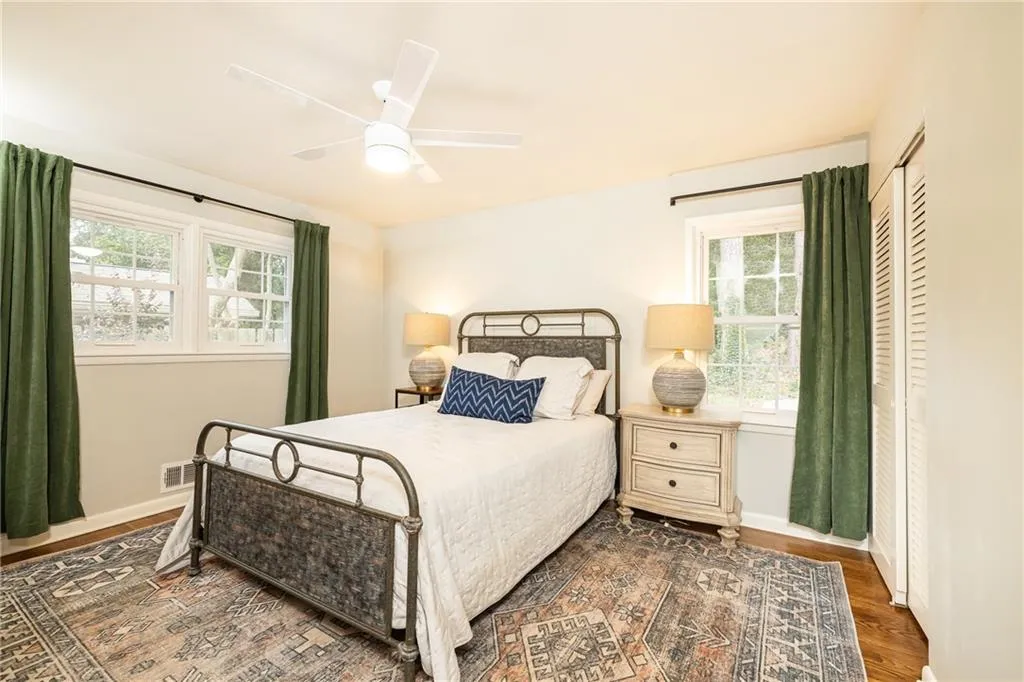 Bedroom with a ceiling fan, wood finished floors, and a closet