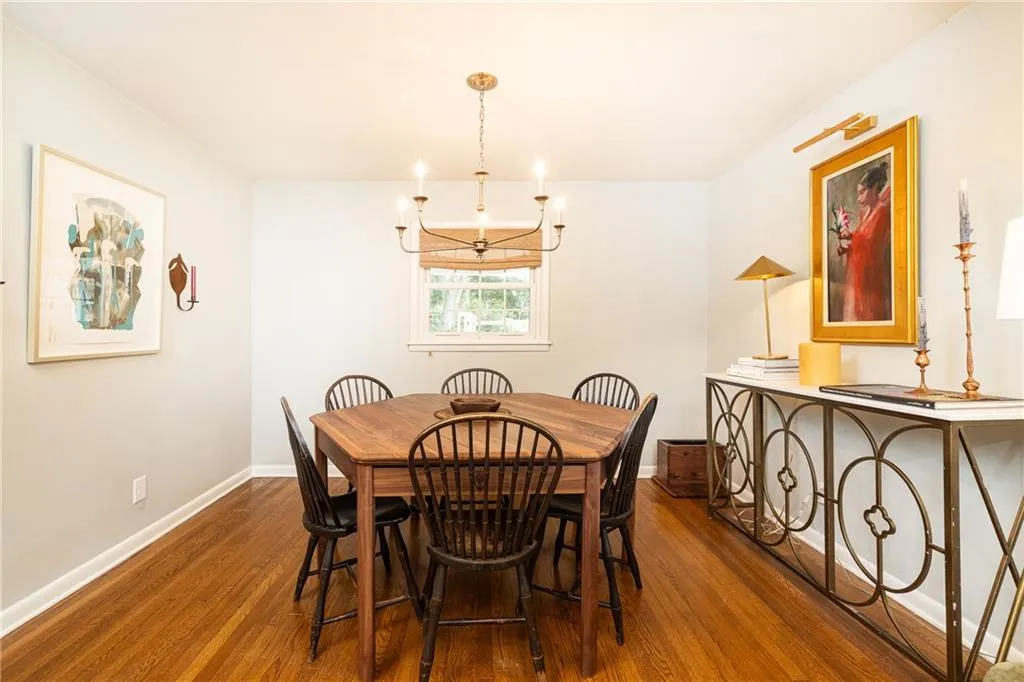 Dining space with hardwood / wood-style floors and suspended lighting
