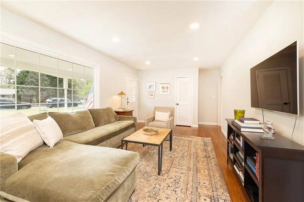 Living area featuring light wood-type flooring and recessed lighting
