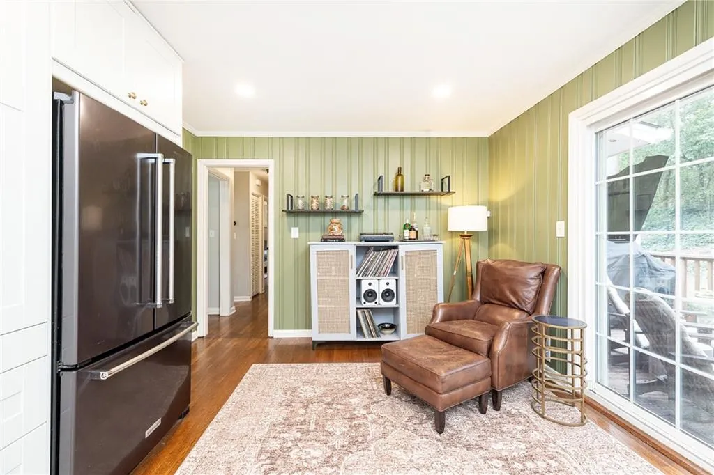 Living area featuring dark wood-style flooring, crown molding, and recessed lighting