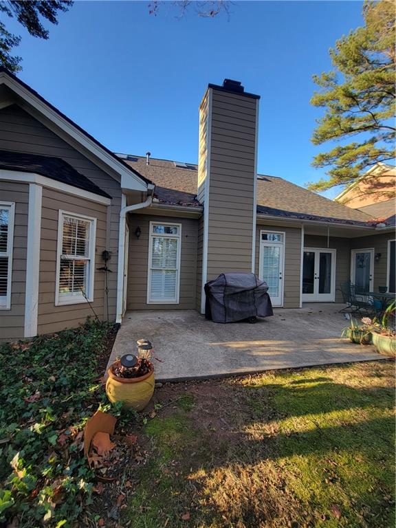 Back of house with a patio area