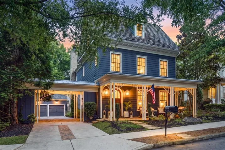 Two-story residence with a dark blue facade, a covered front porch, and a dormer window