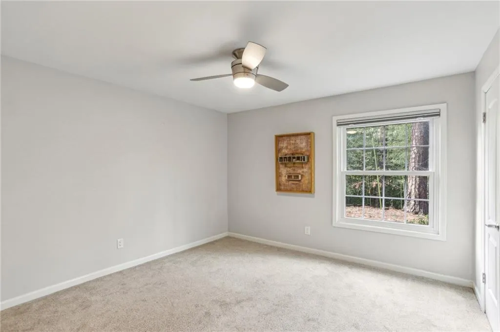 Second bedroom has wooded view and black-out shade to close for privacy..
