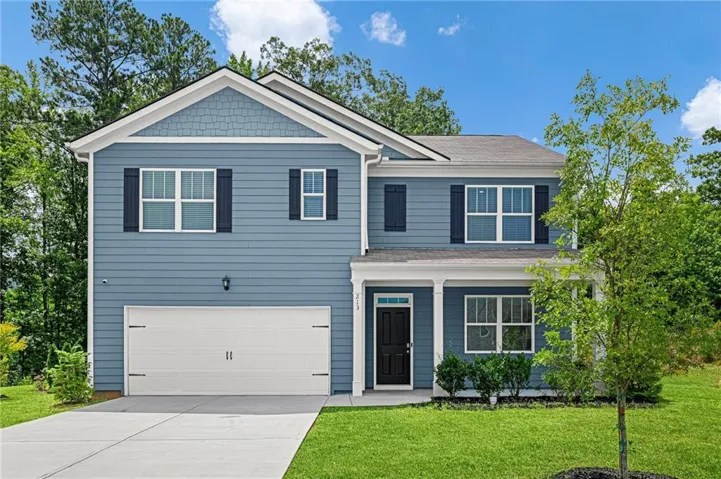 Two-story residence featuring blue siding with white trim, a two-car garage, and a covered front entry with white columns