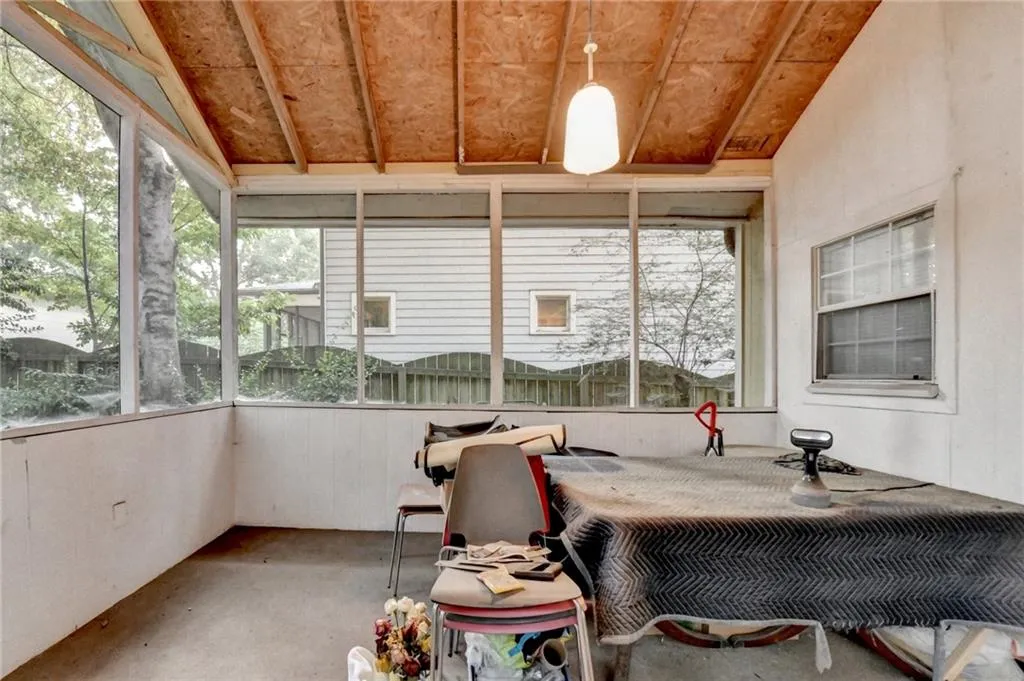 Sunroom / solarium featuring lofted ceiling