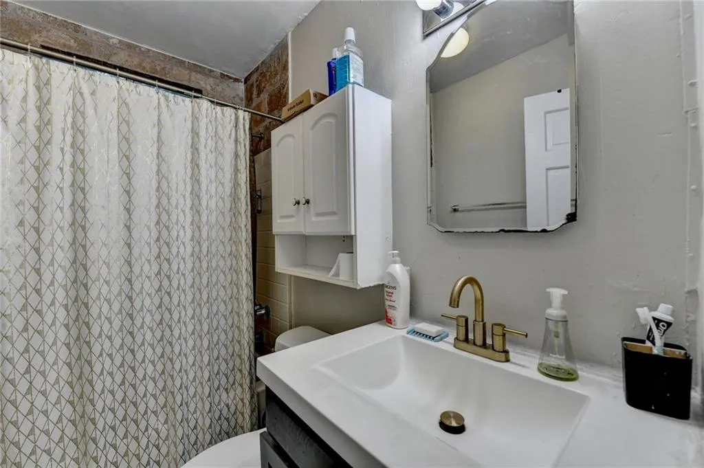 Bathroom with vanity and a shower with shower curtain