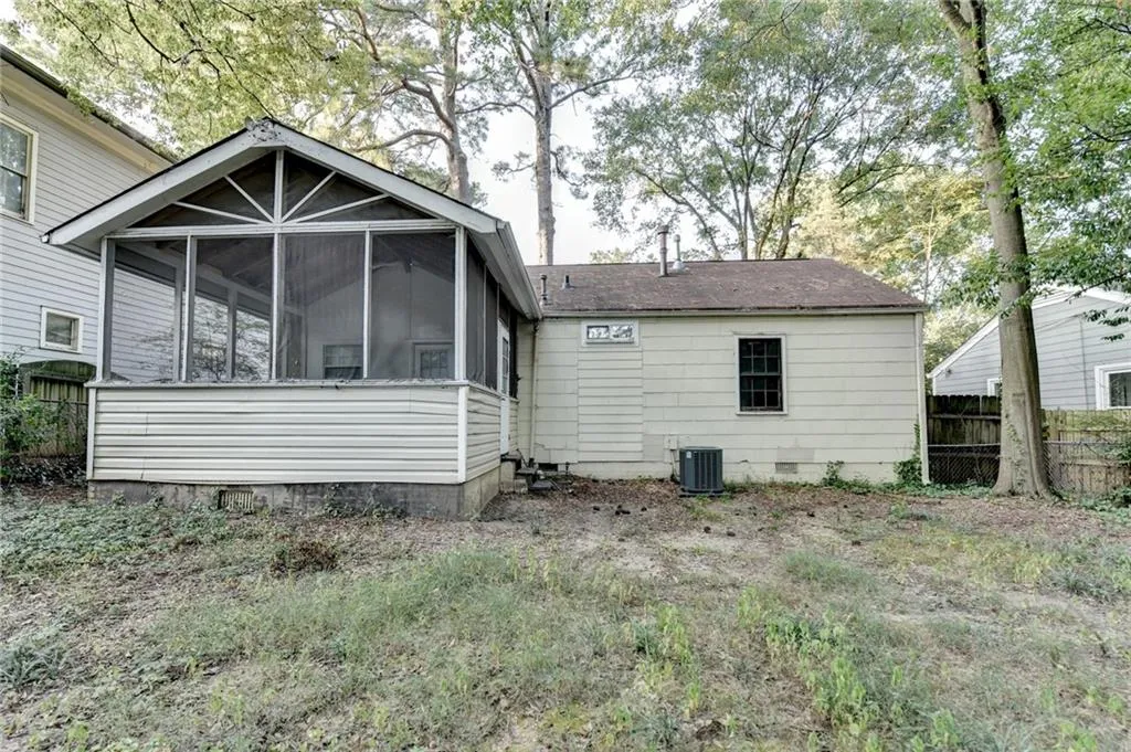 Back of property with a sunroom and crawl space