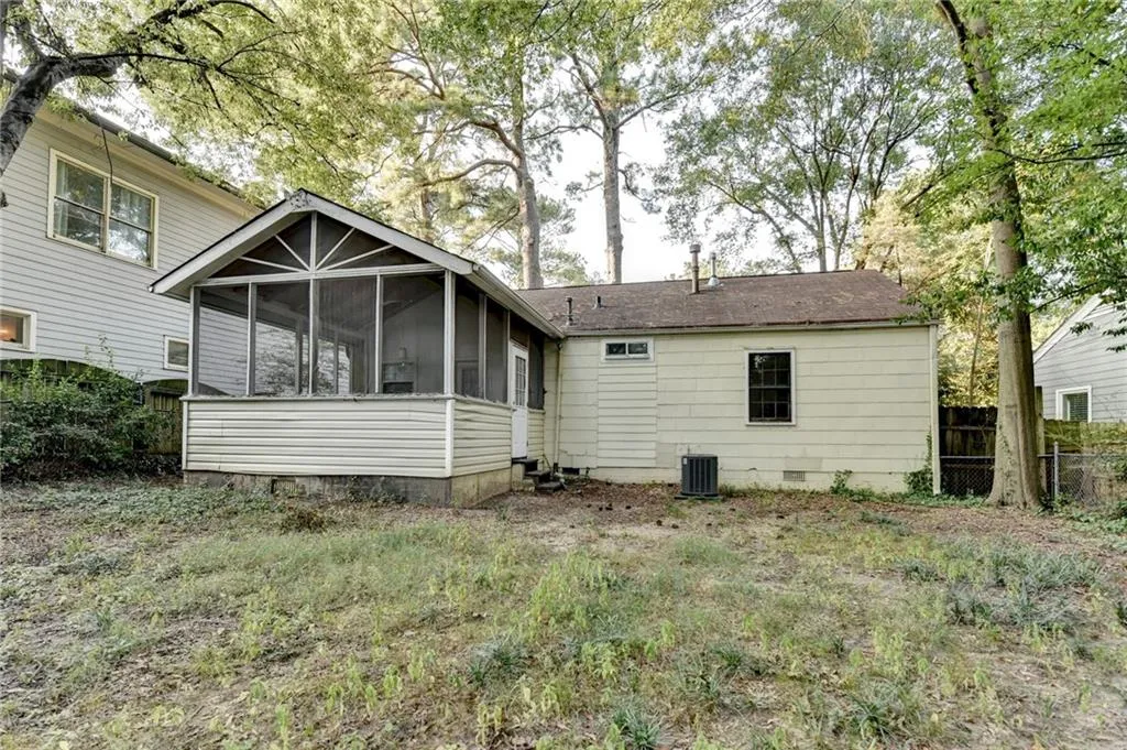Rear view of property featuring a sunroom and crawl space