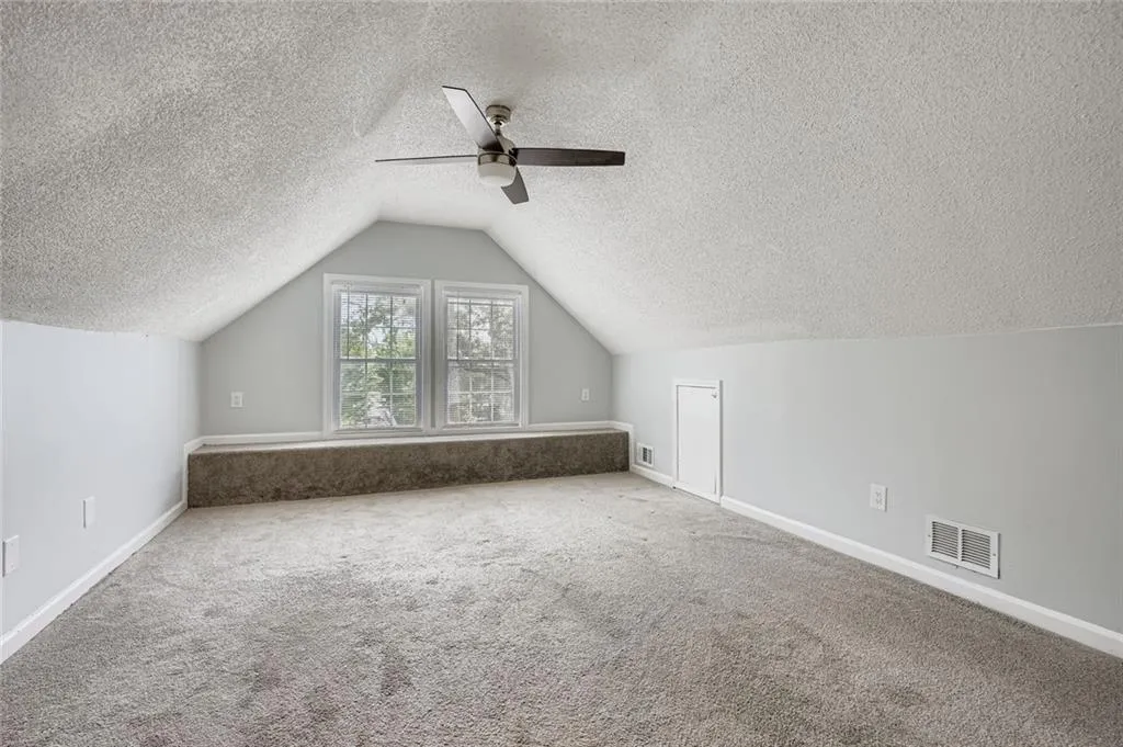 Spacious bonus room on the upper level could alternately be used as a primary bedroom or a flex room.