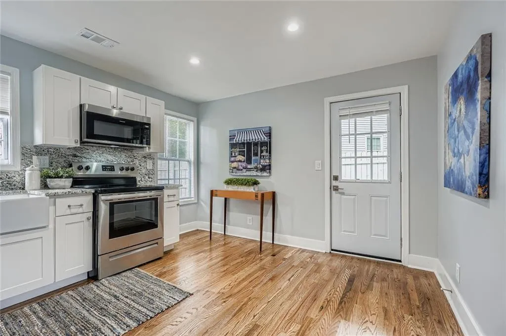 Kitchen can accommodate a bistro table and has a door leading out to the back patio and back yard.