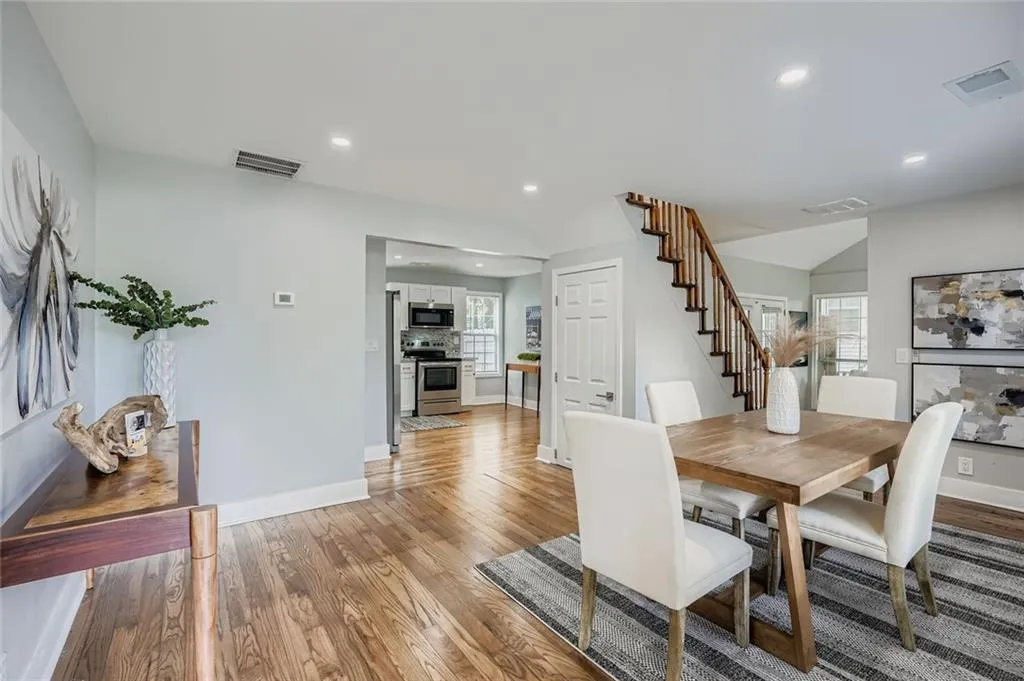 Enter into the home to an open space that can be used for dining or as your main sitting room. Notice the gleaming real hardwood floors.