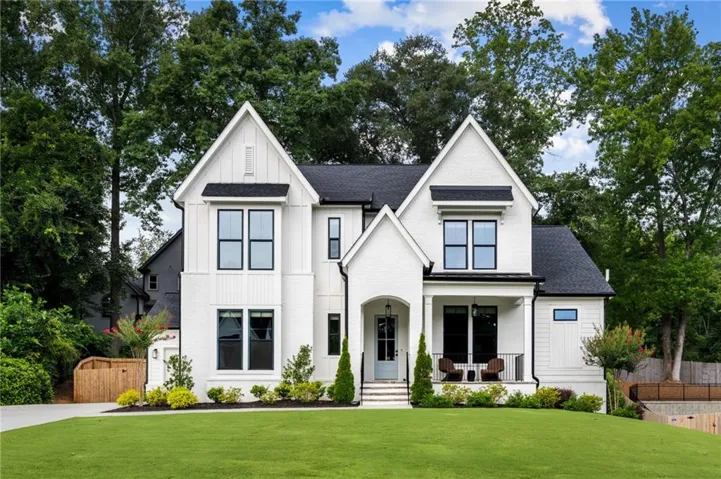 Modern farmhouse-inspired exterior with white painted brick and vertical siding
