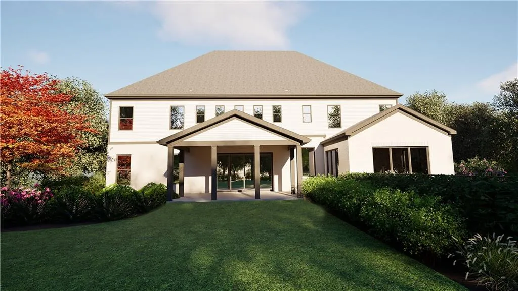 Rear view of house featuring a yard and a patio area
