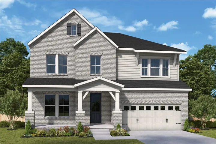 Two-story residence featuring a brick and siding facade, covered front porch, an attached two-car garage, and a dark shingle roof