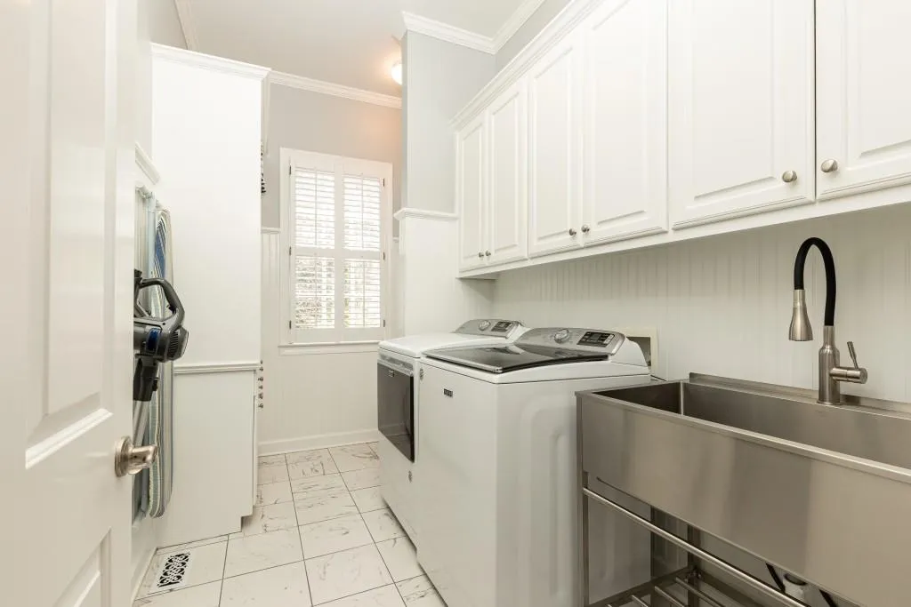 Large updated laundry room with 1/2 bath.