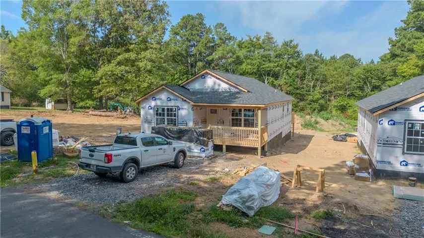 New construction featuring a dark shingle roof and a covered front porch