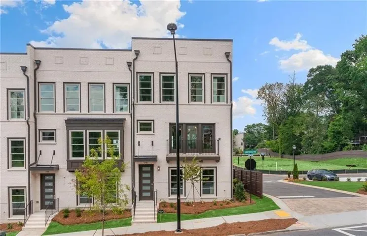 Modern townhome exterior with light brick and dark trim accents