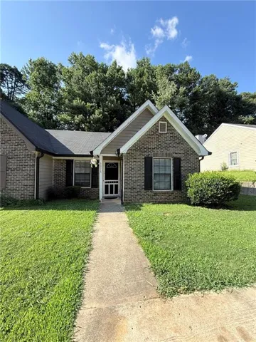 Brick exterior with gabled roof lines and dark shutters