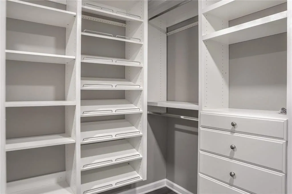 2 of 2 Primary Suites Huge Walk-in Closet with closet systems next to Dressing Area with Additional Closet