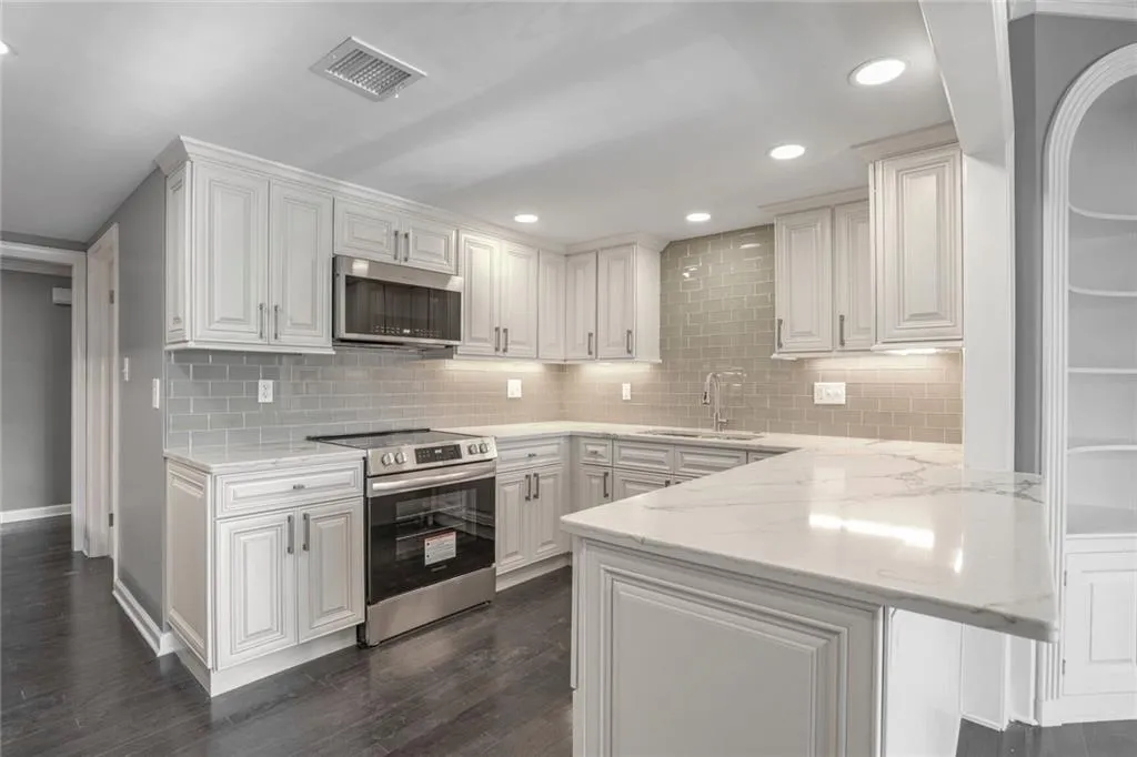 Completely Renovated Kitchen with Quartz Countertops, New Cabinets, and Stainless Steel Appliances.