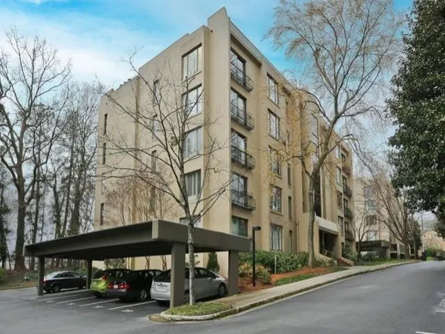 View of Building #3 featuring covered parking