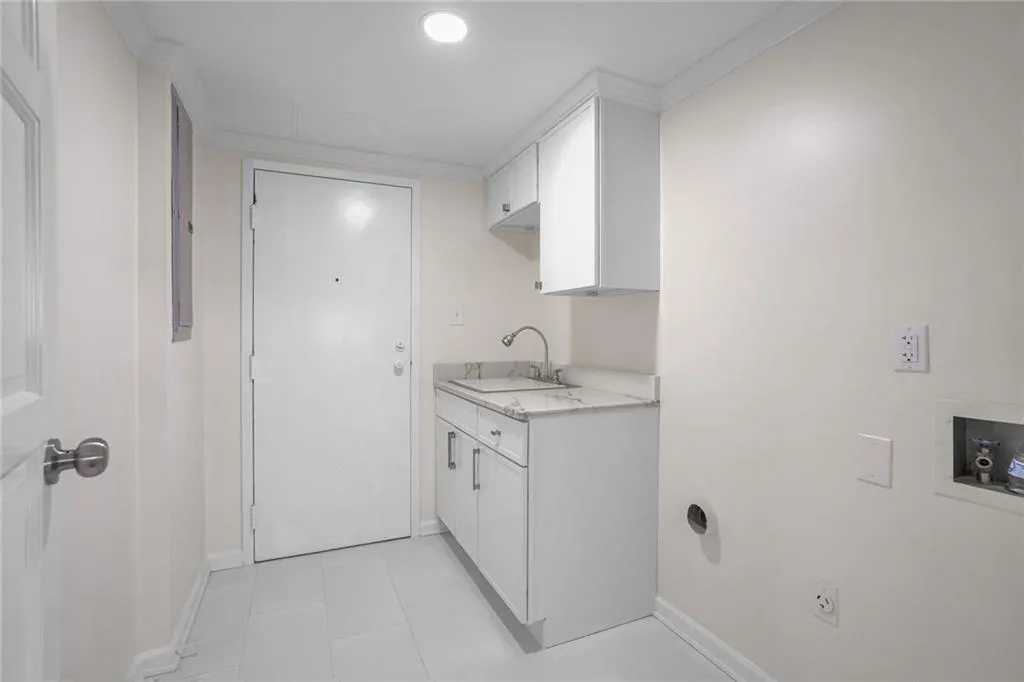 Laundry Room off the Kitchen with Storage access to the back hall, storage, Mechanical Closet and Back Stairs.