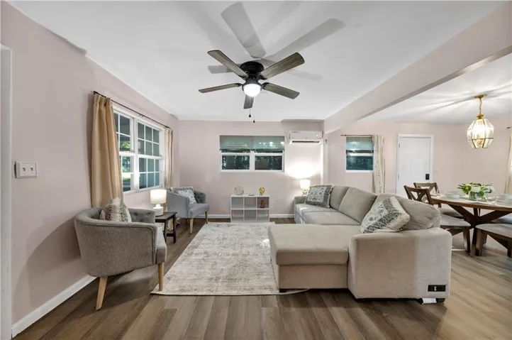 Open concept living area with wood-finish flooring