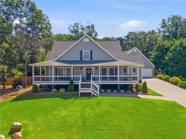 Gray siding residence with a covered front porch featuring white railings