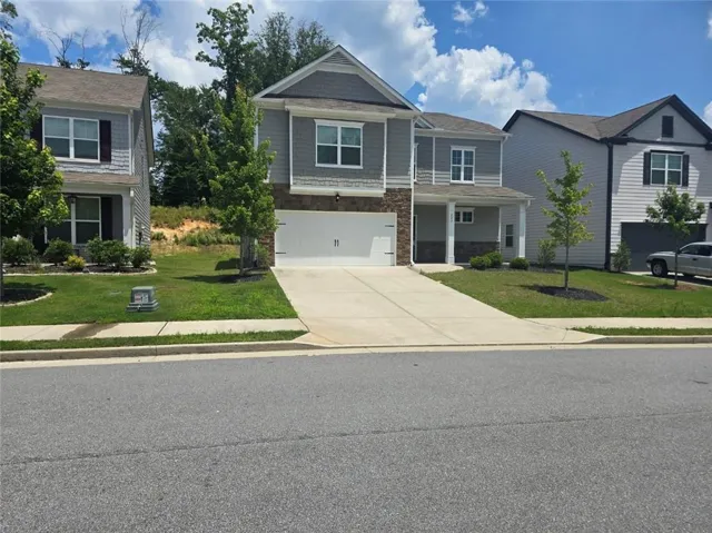 Two-story home with a light gray siding exterior and white trim