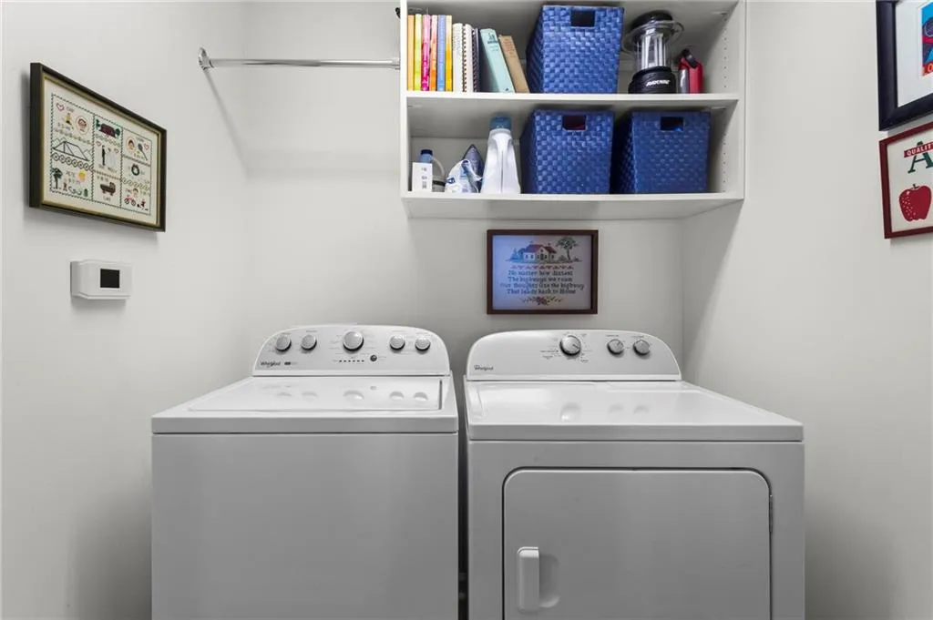 White wall-mounted shelving with integrated hanging rod
