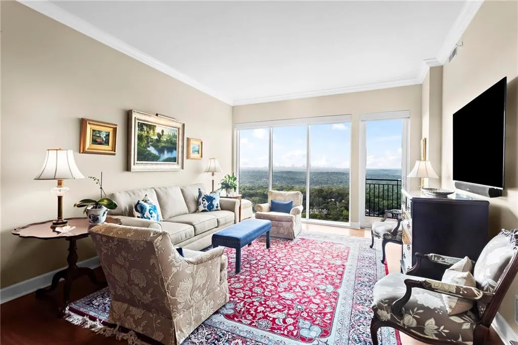 Unit 812 - Hardwood flooring, crown molding, and glass door leading to a balcony with metal railings