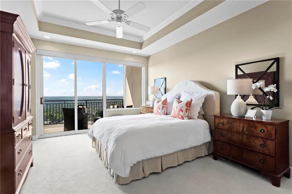 Tray ceiling with crown molding, ceiling fan, and recessed lighting