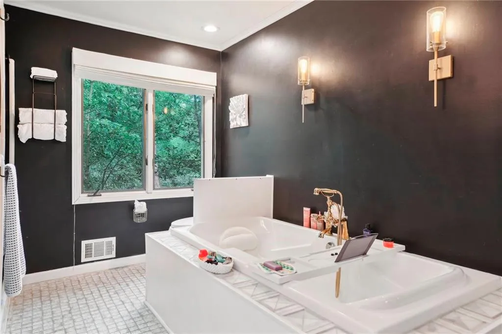 Bathroom featuring tile flooring, a washtub, and ornamental molding