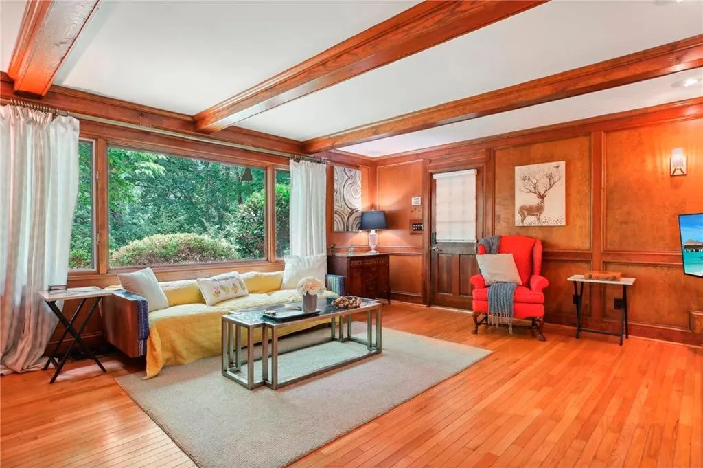 Living room featuring beam ceiling and light hardwood / wood-style flooring