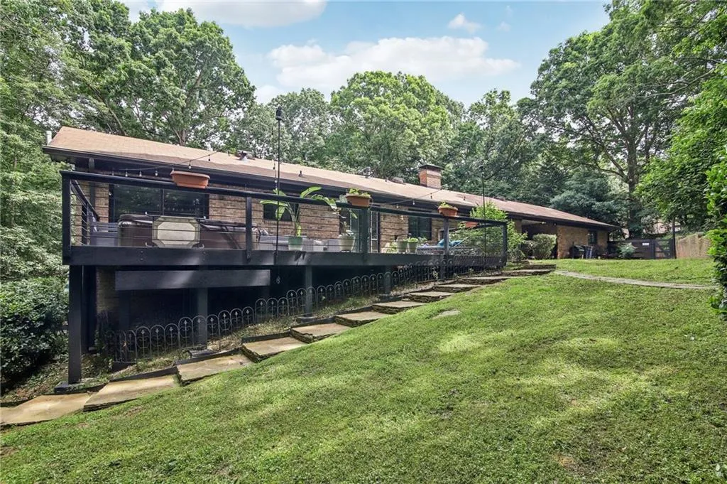 Back of property featuring a yard and a balcony