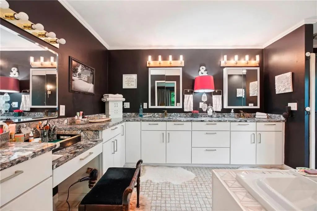 Bathroom featuring tile flooring, ornamental molding, large vanity, and a bathing tub